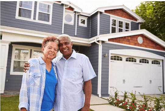 man and woman frnt of a house