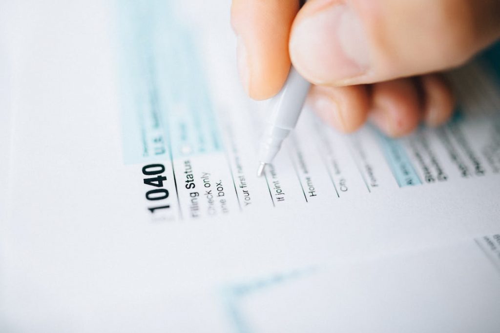 up-close view of person filling out 1040 tax form